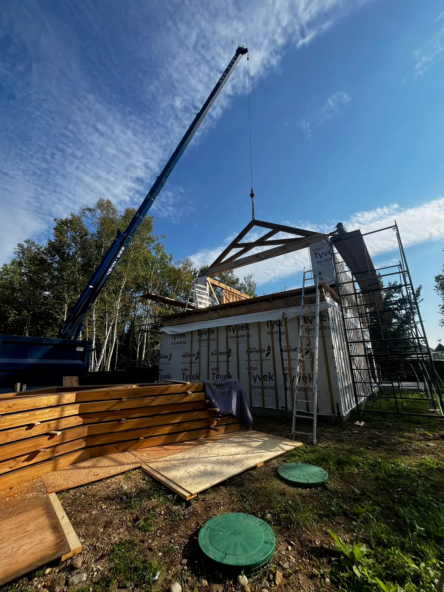 Installation de charpente avec grue sur chantier